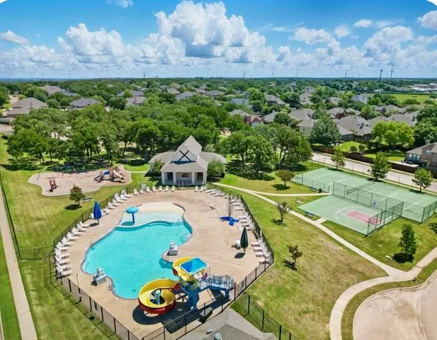 an aerial view of a house with garden space and ocean view