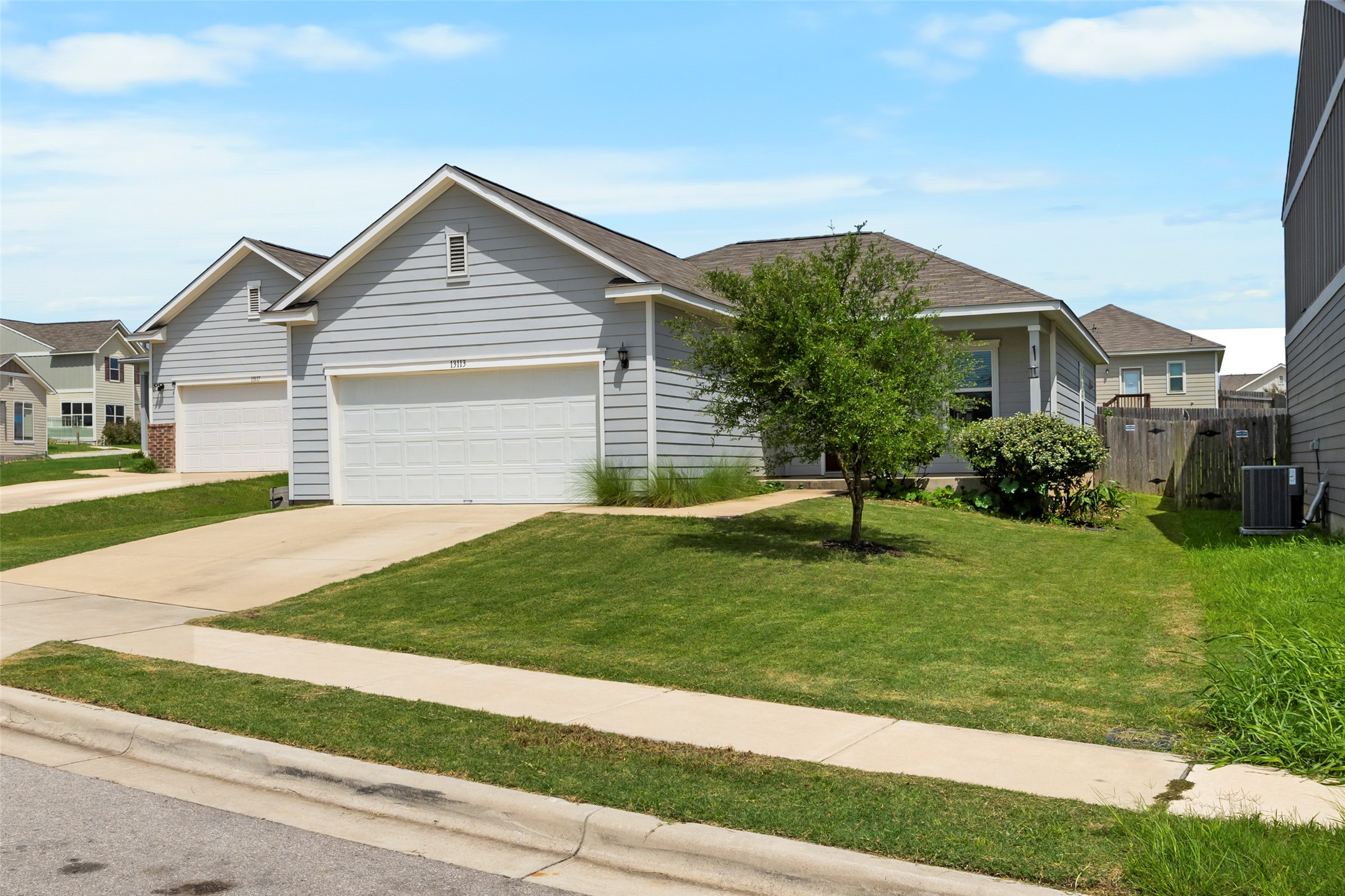 13113 Titanium Street Austin, TX 78754 - Photo 2 of 39 View of front of home featuring an attached garage and spacious driveway