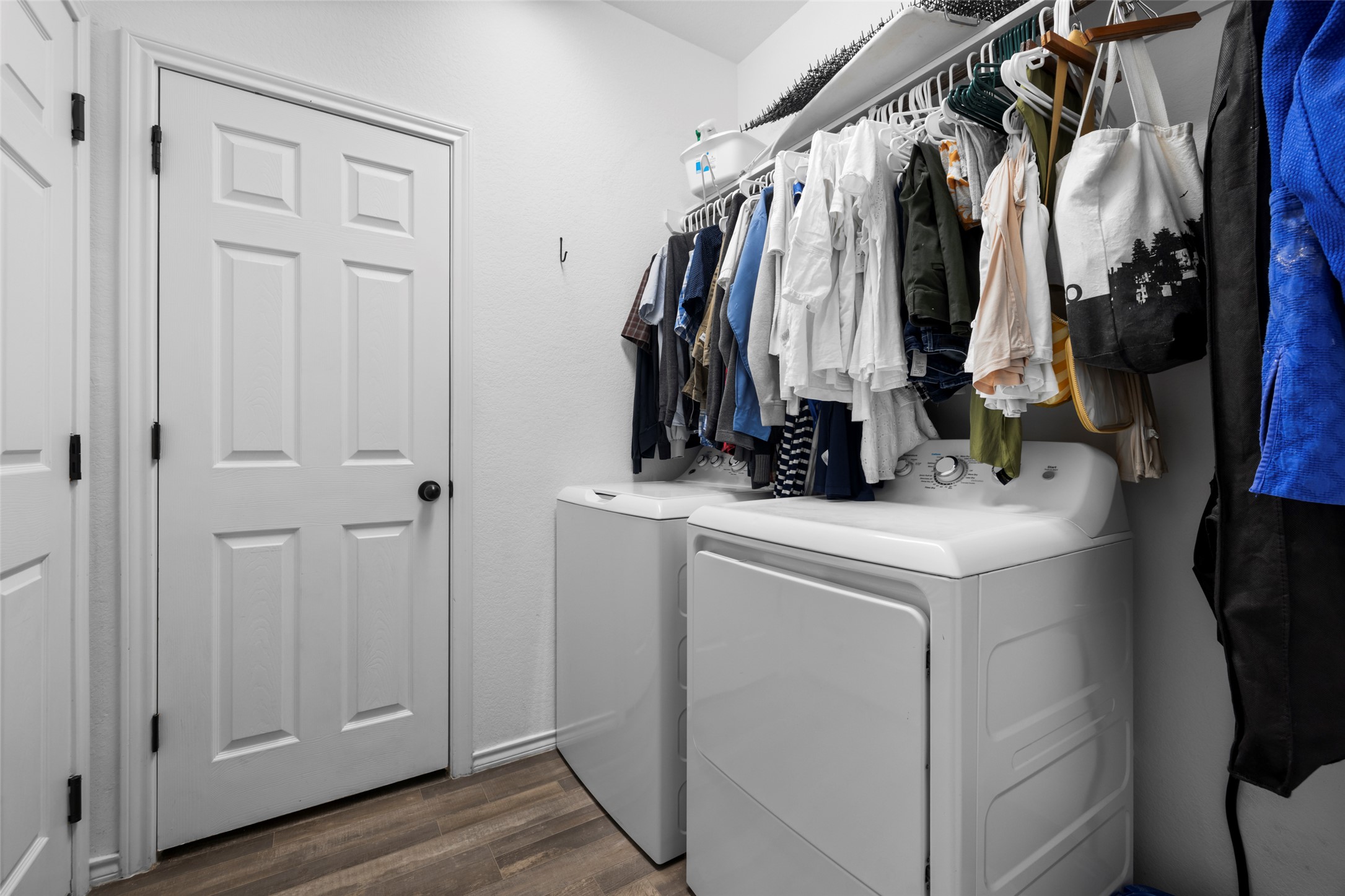 13113 Titanium Street Austin, TX 78754 - Photo 20 of 39 Laundry area with washer and dryer connections and wood look vinyl floors