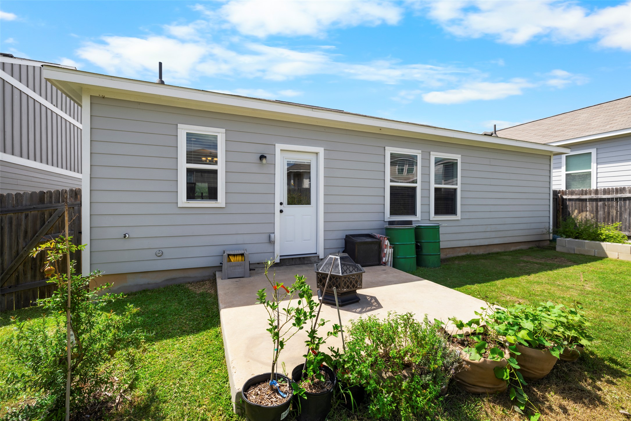 13113 Titanium Street Austin, TX 78754 - Photo 22 of 39 Rear view of house featuring a patio area, a fire pit, and a fenced backyard