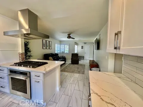 a kitchen with stainless steel appliances a stove a sink and a refrigerator