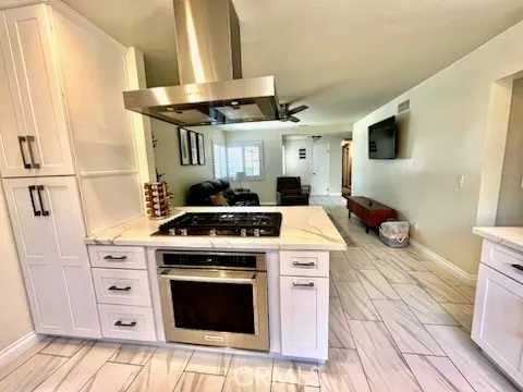 a kitchen with a stove top oven and cabinets