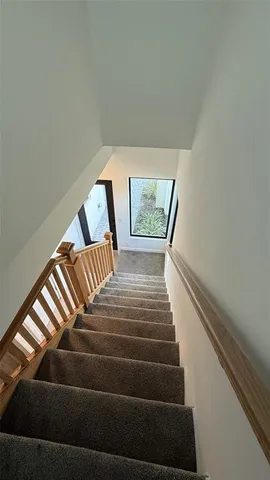 a view of kitchen with kitchen island and windows