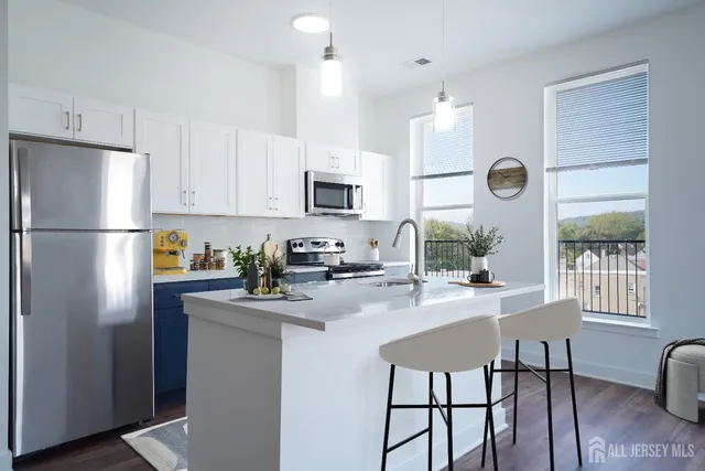 a kitchen with refrigerator cabinets and windows