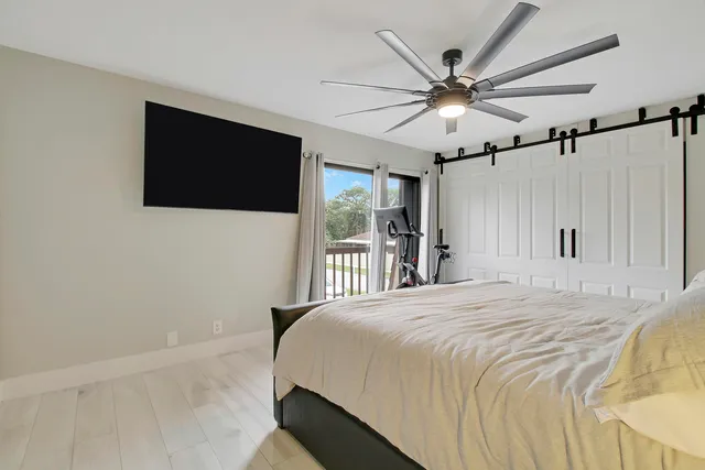 a bedroom with a bed and a flat screen tv