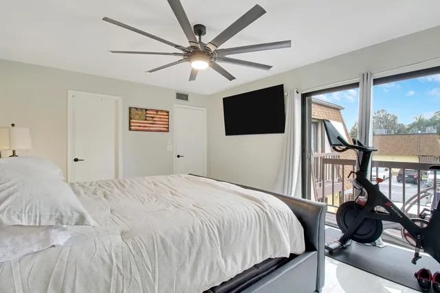 a bedroom with a large bed and a flat tv screen on a dresser
