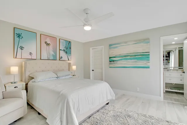 a bedroom with a bed and a painting on the wall