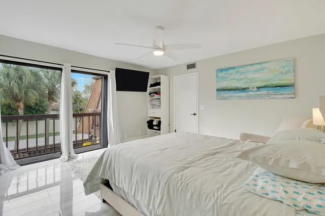 a bedroom with a large bed and a large window