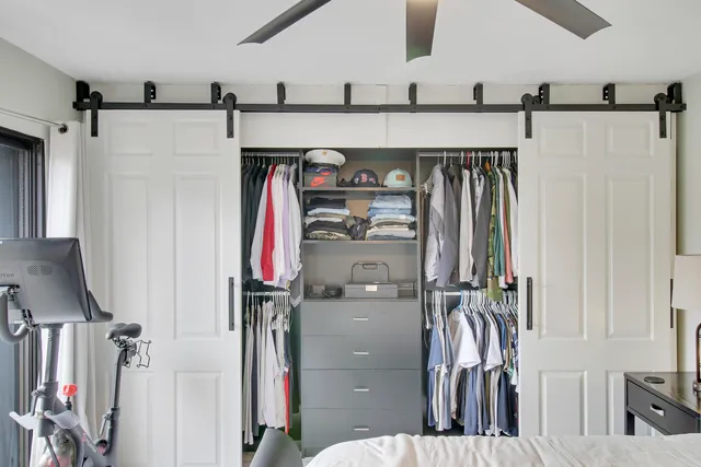 a view of walk in closet with clothes and shoes