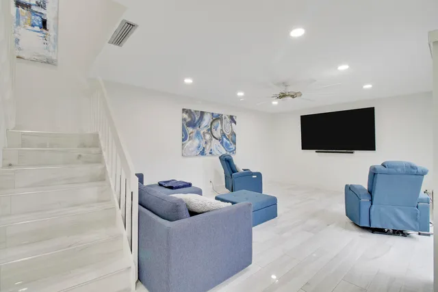 a living room with couches and a flat screen tv