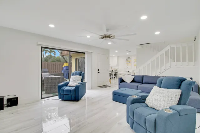 a living room with furniture and a potted plant