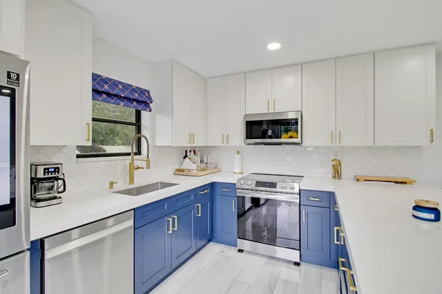 a kitchen with a sink a stove and cabinets