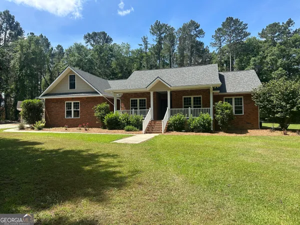 a front view of a house with a garden