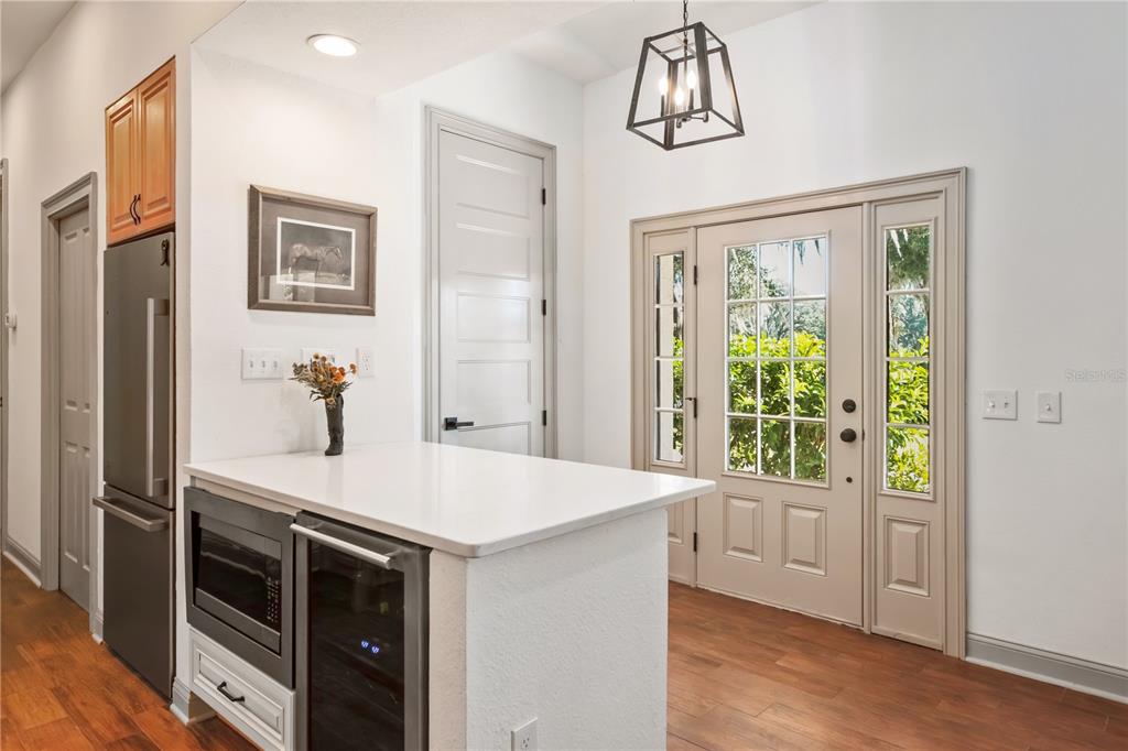 8820 Northwest 130th Street Reddick, FL 32686 - Photo 19 of 67 a kitchen with stainless steel appliances a chandelier and a wooden floor