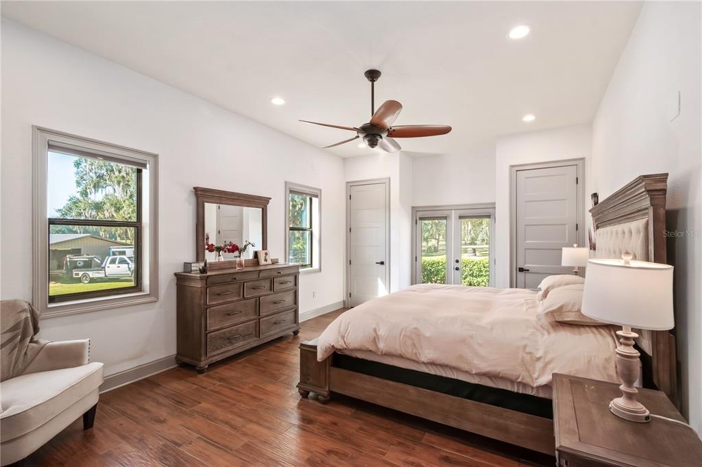 8820 Northwest 130th Street Reddick, FL 32686 - Photo 21 of 67 a bedroom with a bed and a chandelier