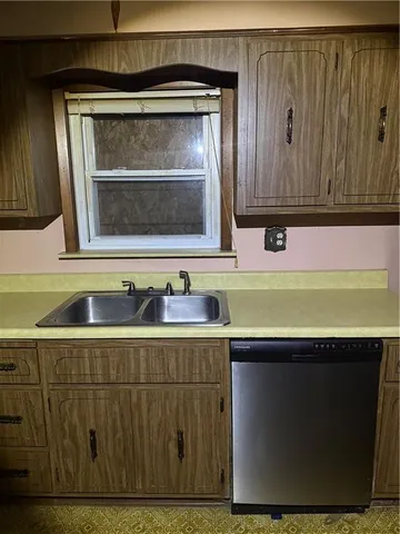 a kitchen with sink and cabinets