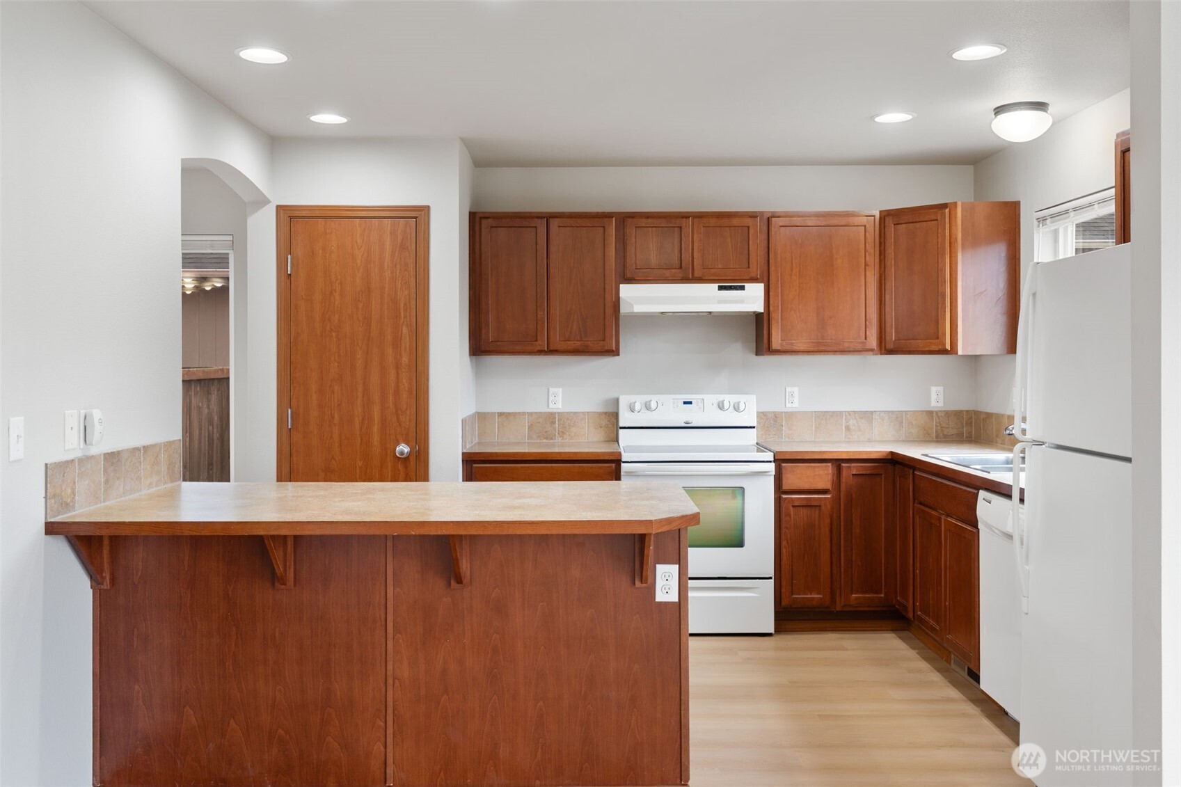 116 Goldmyer Drive Chehalis, WA 98532 - Photo 10 of 38 a kitchen with stainless steel appliances granite countertop a refrigerator a sink dishwasher and wooden cabinets with wooden floor
