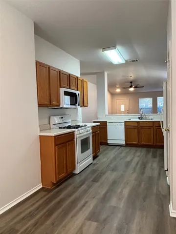 a large kitchen with stainless steel appliances granite countertop a stove and a sink