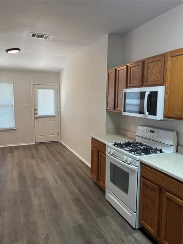 a kitchen with a stove and a microwave