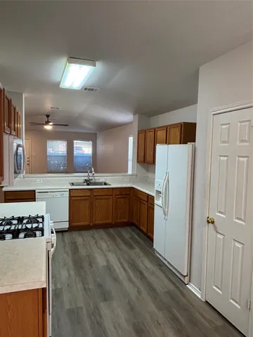 a kitchen with stainless steel appliances a refrigerator and a stove