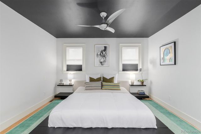 a bedroom with a large bed and a chandelier