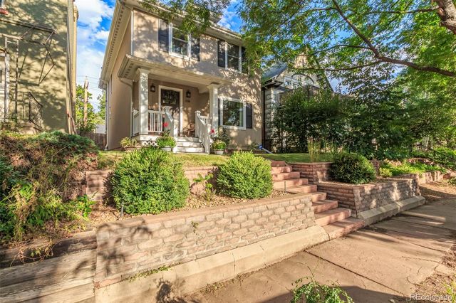 a front view of a house with garden