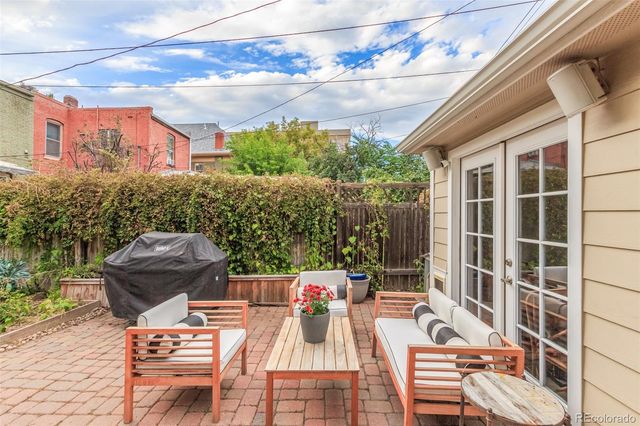 a view of a patio with couches table and chairs and potted plants