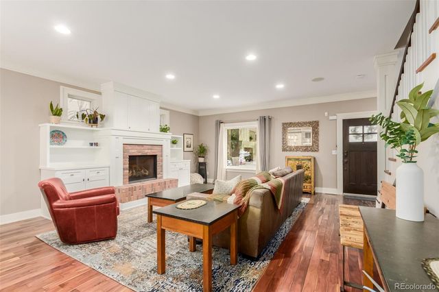 a living room with furniture a fireplace and a table