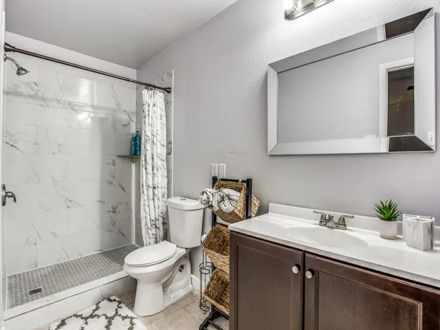 a bathroom with a sink toilet and shower
