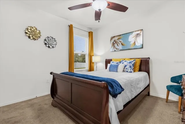 a bedroom with a bed and a painting on the wall