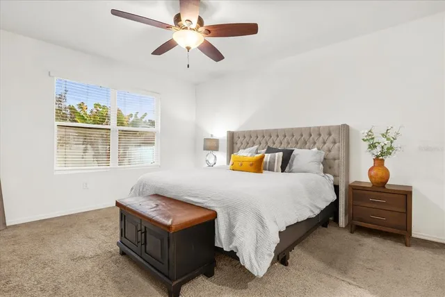 a bedroom with a bed dresser and a window