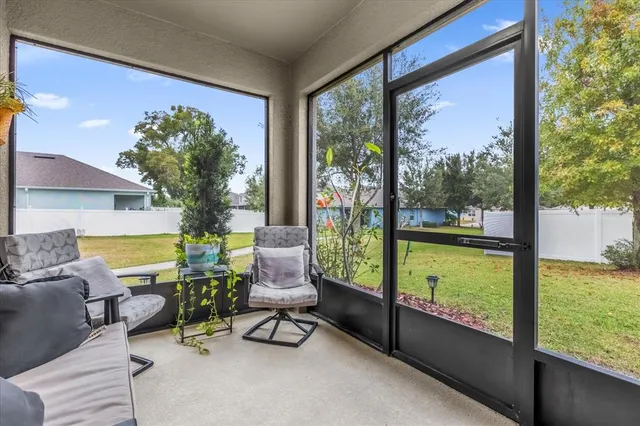 a living room filled with furniture and a potted plant