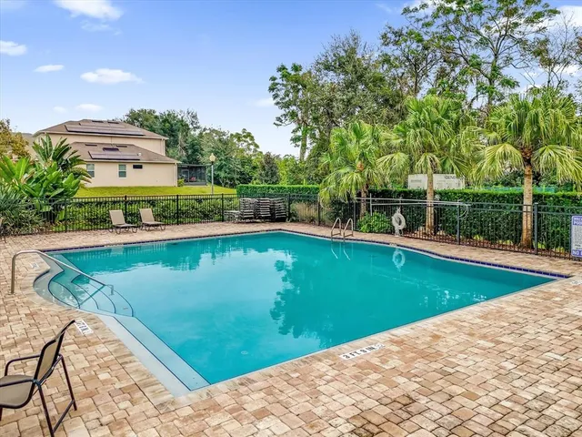 a view of a swimming pool with a yard