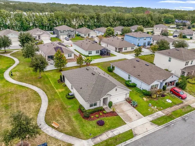 an aerial view of residential houses with outdoor space
