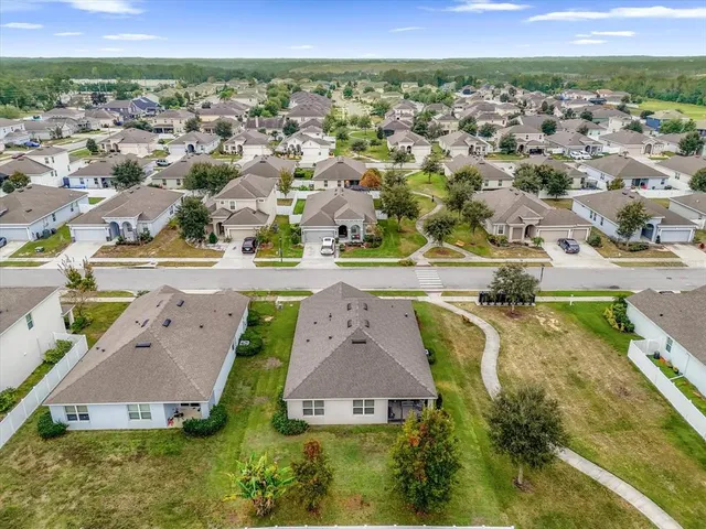 an aerial view of residential houses with outdoor space and swimming pool