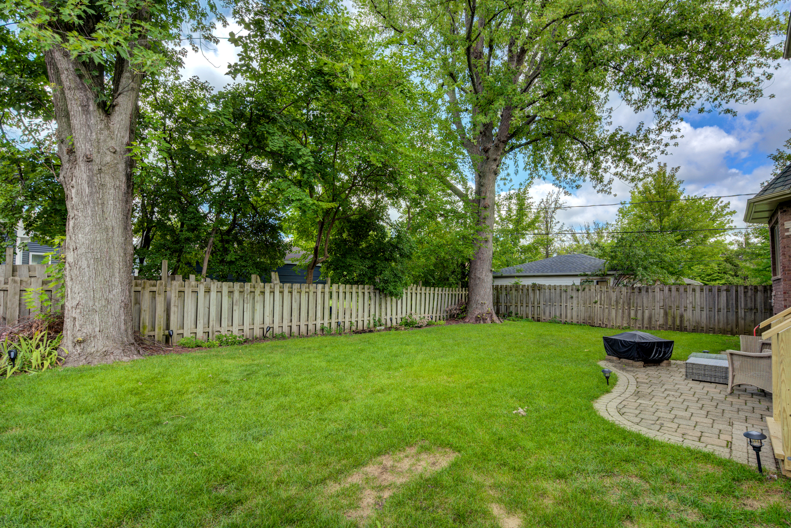 4436 Roslyn Road Downers Grove, IL 60515 - Photo 25 of 30 a view of a backyard with a small cabin and a chair