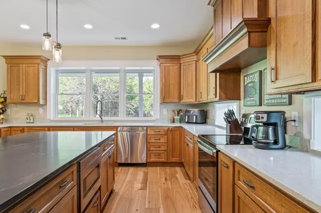 a view of a hallway with wooden floor and entryway