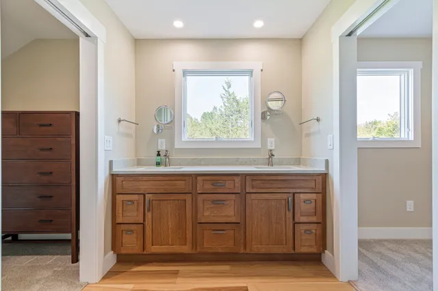 a spacious bathroom with a toilet a sink and a mirror