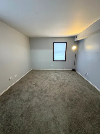 an empty room with mirror and entrance