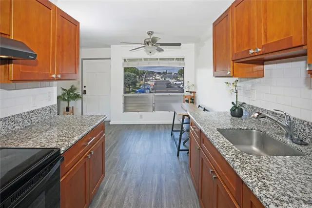 a kitchen with stainless steel appliances granite countertop a sink stove and refrigerator