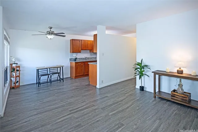 a view of a room with wooden floor and ceiling fan