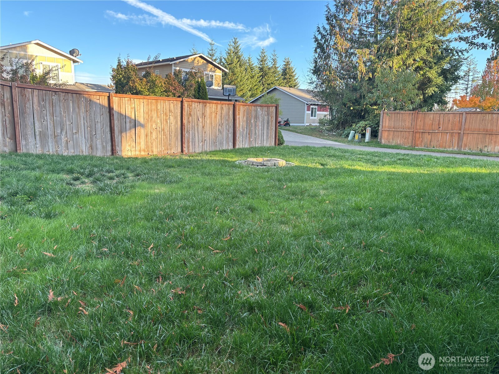 7796 Kildare Loop Northwest Silverdale, WA 98383 - Photo 13 of 14 a backyard of a house with plants and wooden fence