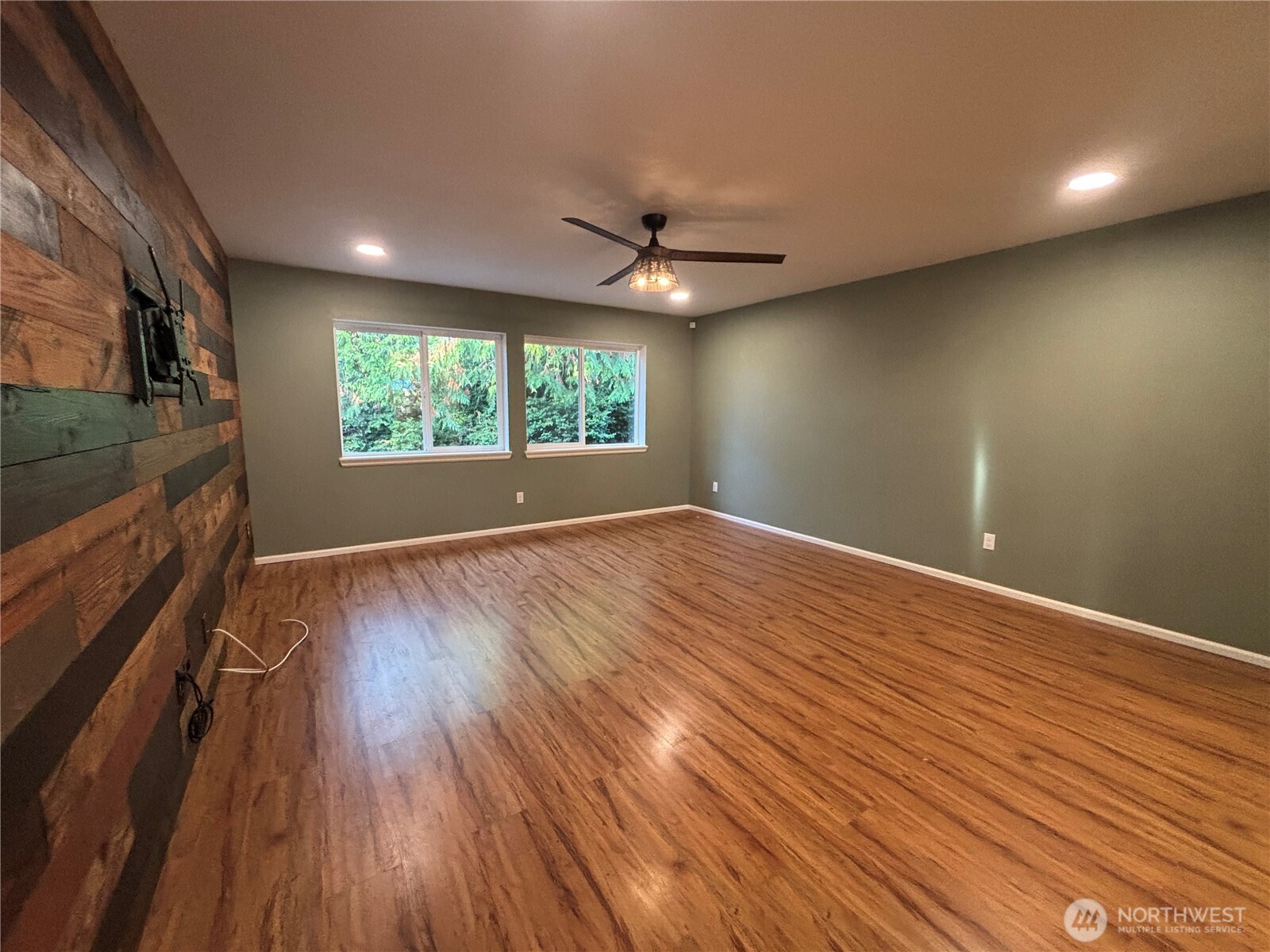 7796 Kildare Loop Northwest Silverdale, WA 98383 - Photo 3 of 14 an empty room with wooden floor and windows