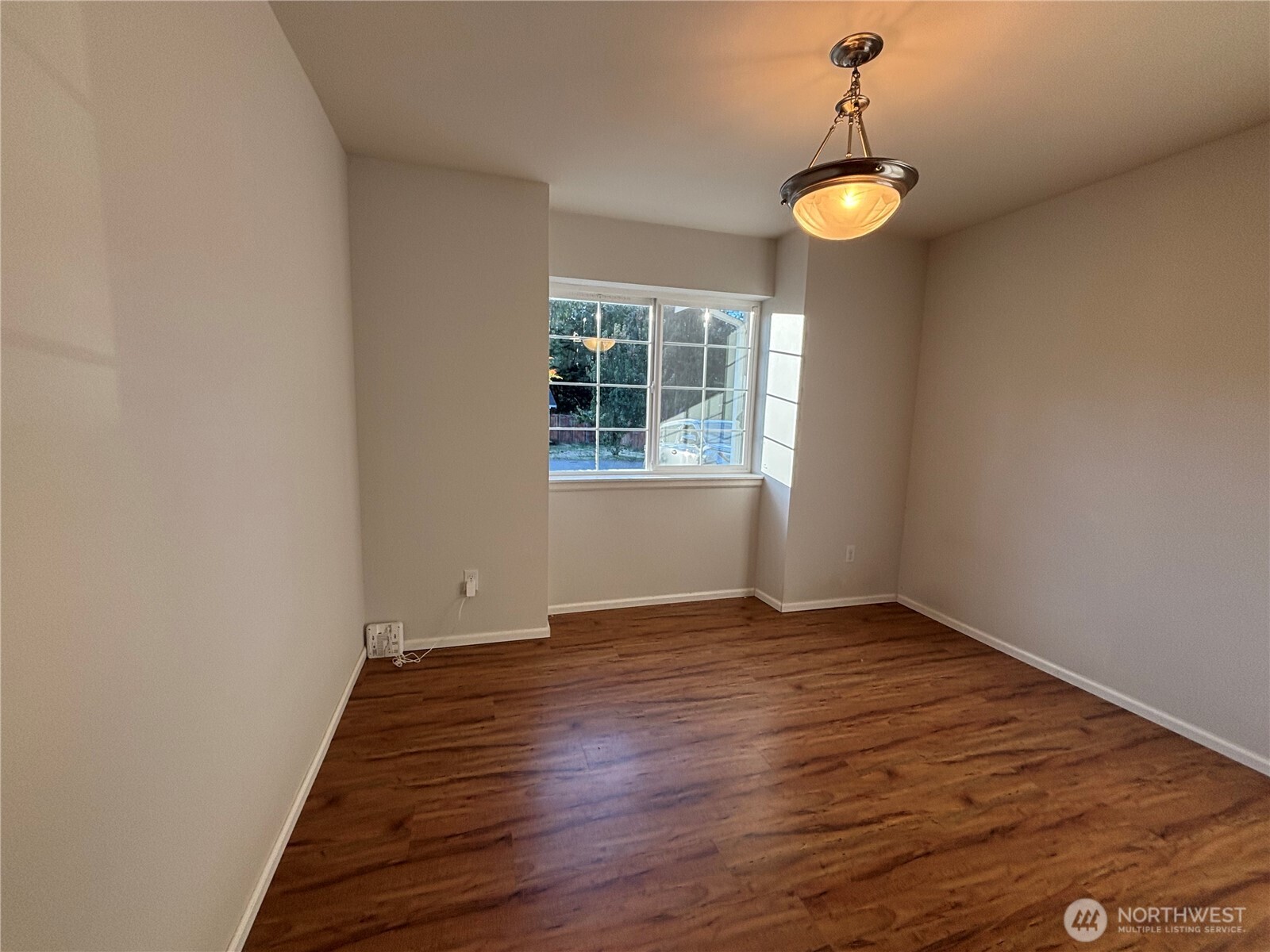7796 Kildare Loop Northwest Silverdale, WA 98383 - Photo 5 of 14 an empty room with wooden floor and windows