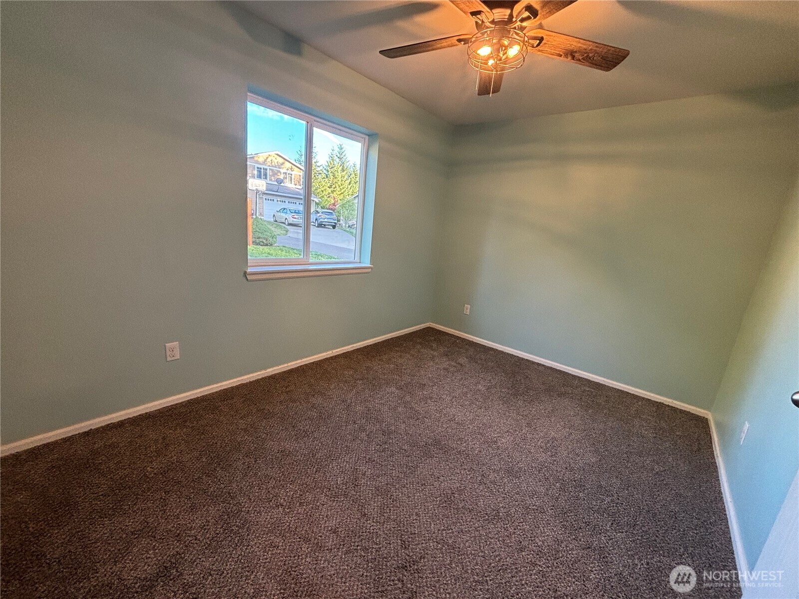 7796 Kildare Loop Northwest Silverdale, WA 98383 - Photo 8 of 14 an empty room with windows and chandelier fan