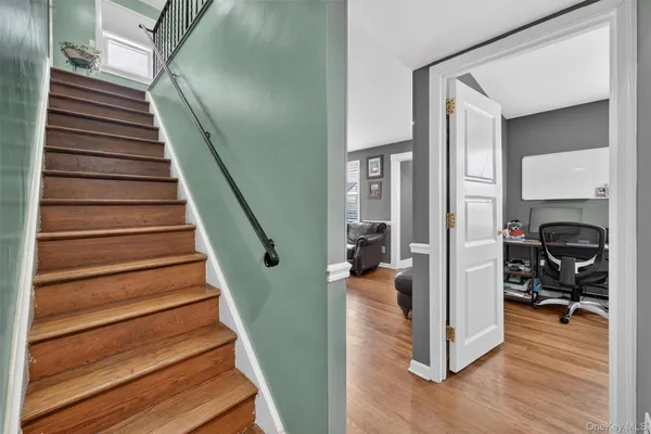 a view of entryway and hall with wooden floor