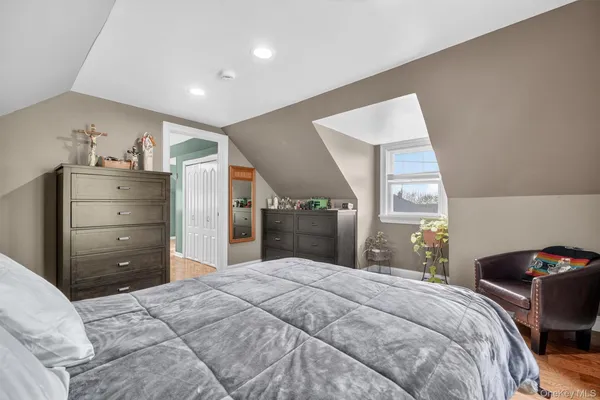 a bedroom with a bed and a mirror
