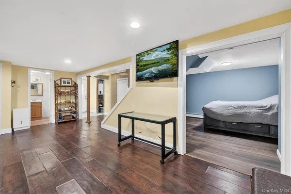 a bedroom with furniture and a wooden floor