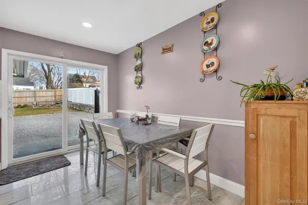 a view of a dining room with furniture and a potted plant