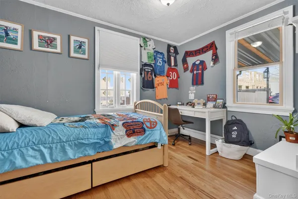 a bedroom with furniture and a wooden floor